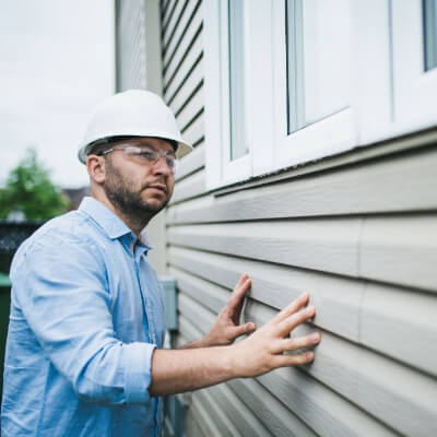 Assessor inspecting house